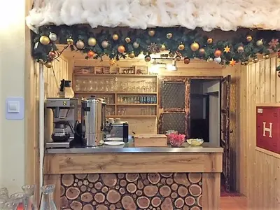 a kitchen with a counter in a kitchen with christmas decorations at Youth Hostel Nika in Kranjska Gora