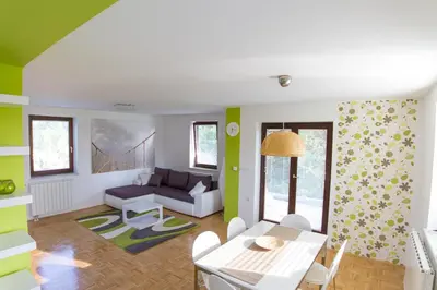 a living room with a table and a couch at D&J house in Ormoz