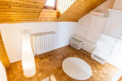 an attic room with a wooden ceiling at D&J house in Ormoz