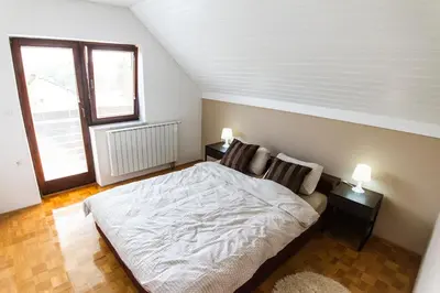 a bedroom with a white bed and a window at D&J house in Ormoz