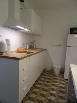 a small kitchen with white cabinets and a sink at Apartma Nadja with private parking in Ljubljana