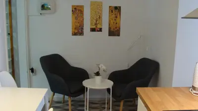 two black chairs and a table in a room at Apartma Nadja with private parking in Ljubljana