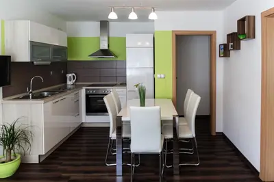 a kitchen with a dining room table and chairs at Apartma Groš in Kranjska Gora