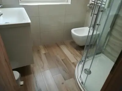 a bathroom with a shower and a toilet and a sink at Apartma Groš in Kranjska Gora