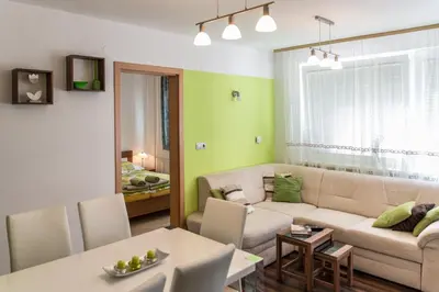 a living room with a couch and a table at Apartma Groš in Kranjska Gora