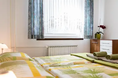 a bedroom with two beds and a window at Apartma Groš in Kranjska Gora