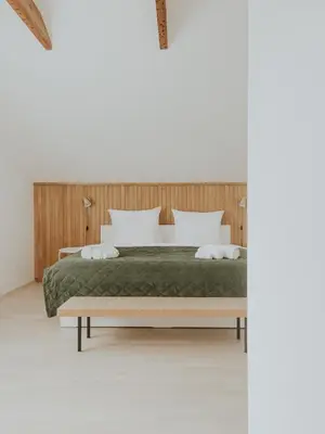 a bedroom with a bed and a wooden headboard at Home in Bled in Bled