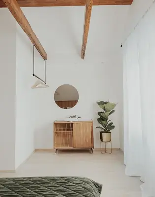 a bedroom with a table and a potted plant at Home in Bled in Bled