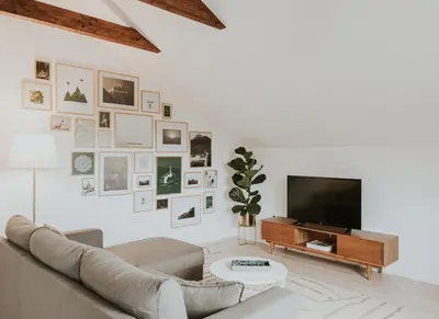 a white living room with a couch and a tv at Home in Bled in Bled