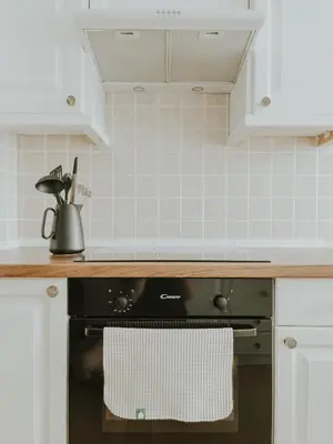 a kitchen with a black oven with a towel on it at Home in Bled in Bled