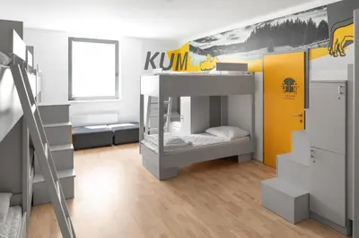 a bedroom with a bunk bed and a yellow wall at Youth Hostel Trbovlje in Trbovlje