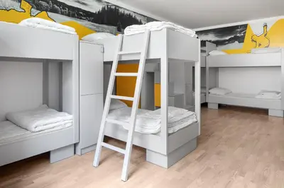 a room with three bunk beds and a ladder at Youth Hostel Trbovlje in Trbovlje