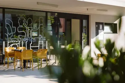 a patio with chairs and tables in a building at Youth Hostel Trbovlje in Trbovlje
