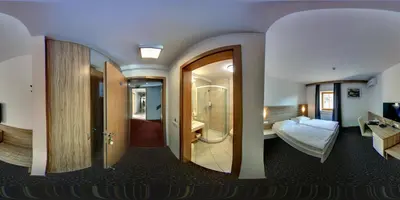 a hotel room with a bed and a bathroom at Domačija Vodnik & Apartments in Cerklje na Gorenjskem