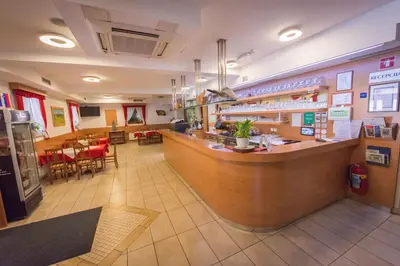 a restaurant with a bar and a dining area at Domačija Vodnik & Apartments in Cerklje na Gorenjskem