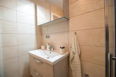 a bathroom with a sink and a mirror at Apartment Stil near Terme Paradiso in Dobova