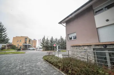 a building with a stop sign next to a street at Apartment Stil near Terme Paradiso in Dobova