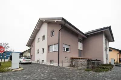 a building with a car parked in front of it at Apartment Stil near Terme Paradiso in Dobova