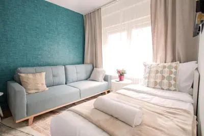a living room with a couch and a bed in it at Apartment Artorius Ljubljana in Ljubljana