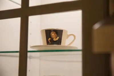a coffee cup sitting on a glass shelf at Apartment Artorius Ljubljana in Ljubljana