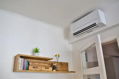 a room with a wall mounted air conditioner on a wall at Historic Mexico Building Apartment in Ljubljana