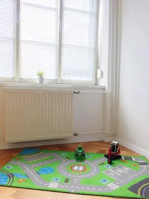a toy race track rug on the floor in a room at Historic Mexico Building Apartment in Ljubljana