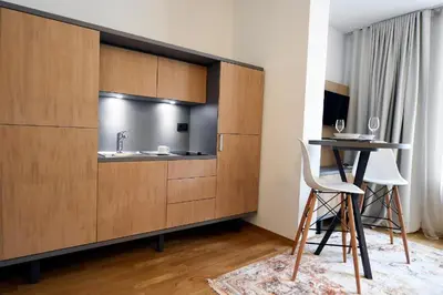 a bathroom with a sink and a desk with a chair at City Centre Chic Apartment Ljubljana 2/4 in Ljubljana