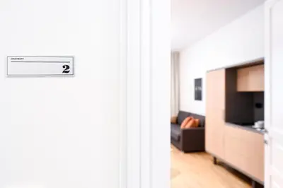a living room with a couch and a television at City Centre Chic Apartment Ljubljana 2/4 in Ljubljana