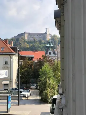a view of a city with a castle in the background at City Centre Chic Apartment Ljubljana 2/4 in Ljubljana