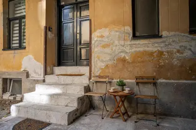 a set of stairs next to a building with a table at Kenti Residence in Ljubljana