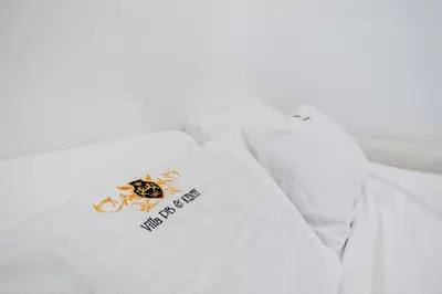 a white pillow with a new dog tag on it at Kenti Residence in Ljubljana