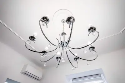 a chandelier hanging from a ceiling in a room at Kenti Residence in Ljubljana