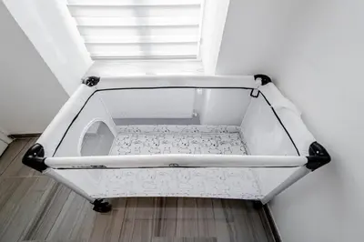 a white cart sitting on the floor next to a window at Kenti Residence in Ljubljana