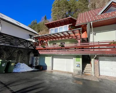 a house with two garage doors in a driveway at Apartma Felix in Kranjska Gora