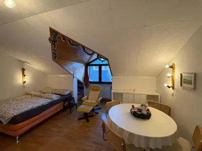 a bedroom with a bed and a table in a room at Apartma Snežko in Kranjska Gora