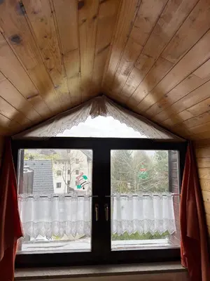 a window in a room with a curtain at Apartma Snežko in Kranjska Gora