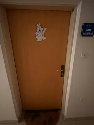 a door with a teddy bear sticker on it at Apartma Snežko in Kranjska Gora