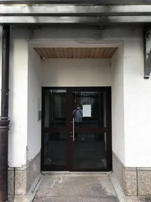 a door to a building with a sign on it at Apartma Snežko in Kranjska Gora