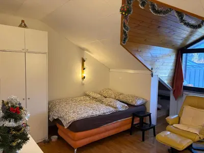 a bedroom with a bed and a chair at Apartma Snežko in Kranjska Gora