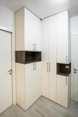 a white kitchen with white cabinets and a door at APARTMA KATKA Vila Mojca in Kranjska Gora