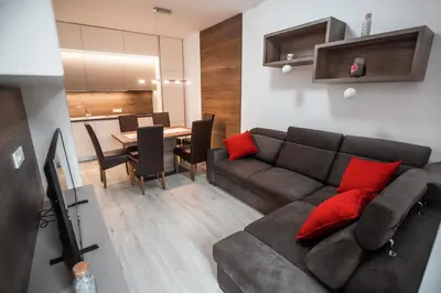 a living room with a couch and a table at APARTMA KATKA Vila Mojca in Kranjska Gora