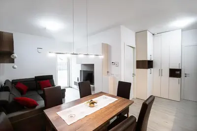 a living room with a table and a couch at APARTMA KATKA Vila Mojca in Kranjska Gora