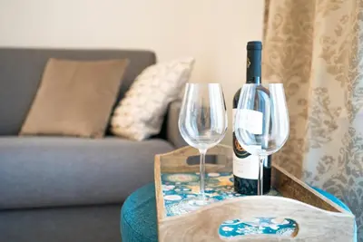 a bottle of wine and two glasses on a table at Hiša 109 in Kranjska Gora