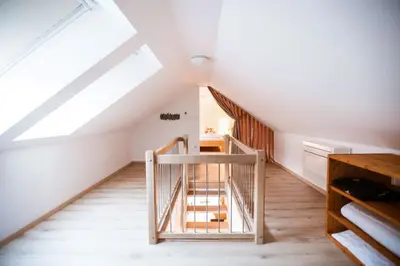 a staircase in a attic with a skylight at Hiša 109 in Kranjska Gora