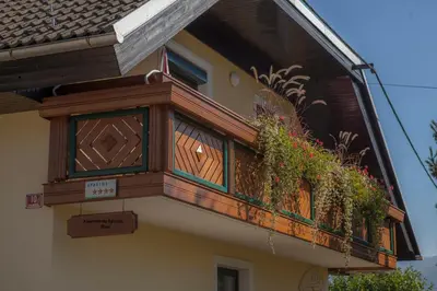 a balcony on the side of a house with plants at Apartments Special Bled in Bled