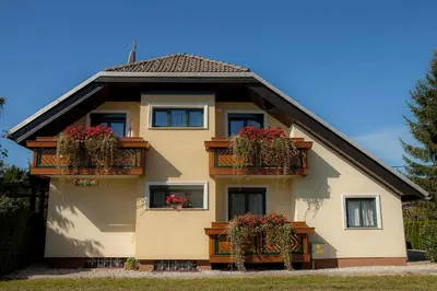 a house with flower boxes on its windows at Apartments Special Bled in Bled