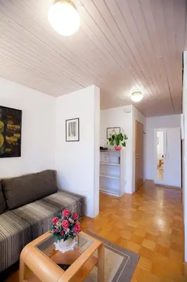a living room with a couch and a table at Apartments Special Bled in Bled