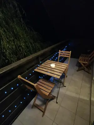 a wooden table and chairs sitting on a patio at Apartma LINA, Encijan D-38 in Bohinj