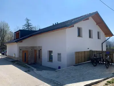 a white house with bikes parked outside of it at Old Boatman's House in Bled