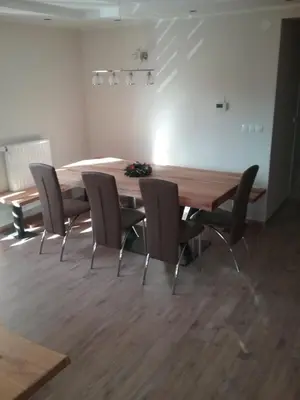 a dining room with a wooden table and chairs at Hudinja 111 in Vitanje